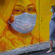 A pregnant woman walks past a street mural in Hong Kong on March 23, 2020.